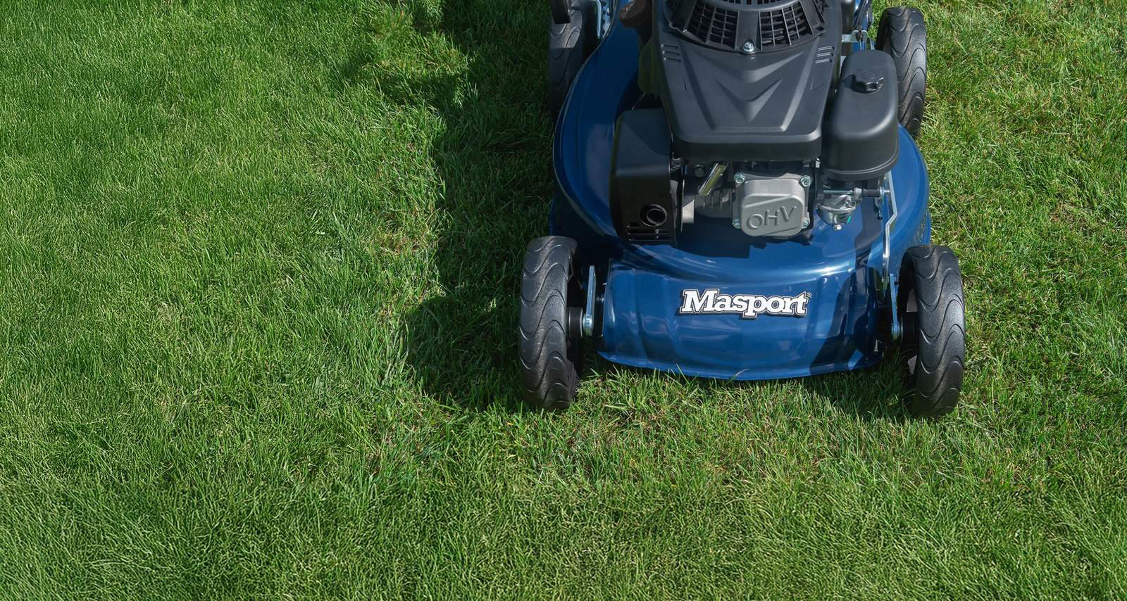 Close-up of a Masport aluminium mower deck cutting grass